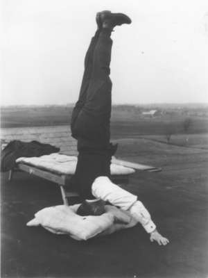 Edgar Fischer standing on his head on the roof of Willison Hall