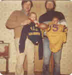 Wilfrid Laurier University alumni Pete Walker and Rob Etherington holding their sons