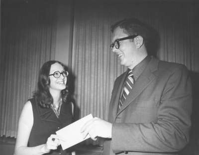 Grant Erwin presents Janet Lautenschlager with scholarship