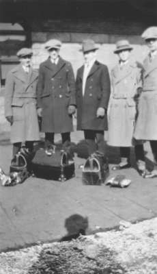 Five students standing on a platform