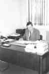 Frank Turner sitting at a desk