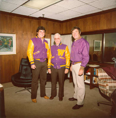 Neale Tayler receiving Lettermen's Club jacket