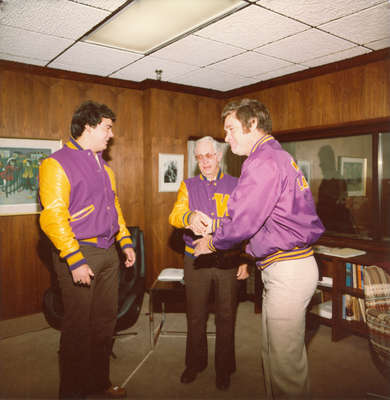 Neale Tayler receiving Lettermen's Club jacket