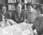 Women's Auxiliary members holding a quilt