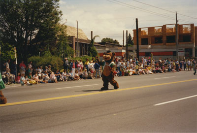 Community Day Parade (figure in bear costume)