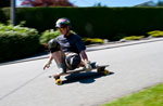 Longboarder at Queens & 12th