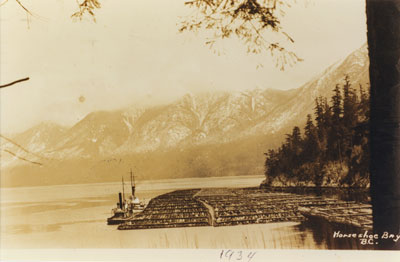 Tug boats with log booms in Horseshoe Bay in 1934