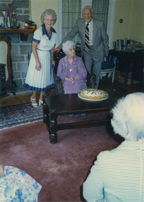 Gertrude Lawson posing with Grace and Rupert Harrison at her 95th birthday party