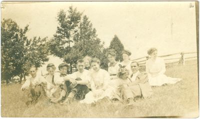 Men, Women and Child Sitting in Field