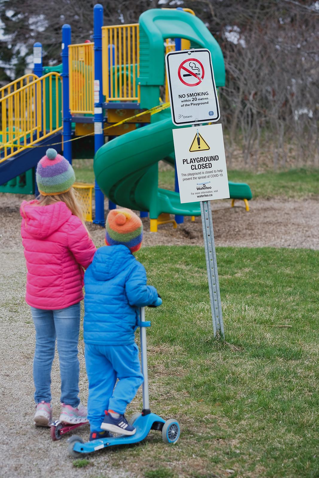 Children Looking at Closed Playground