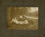 Group of Men and Women having a picnic.