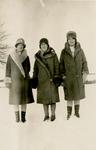 Three women standing outside in the snow