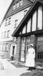Nurse in Front of Residence, C. 1930.