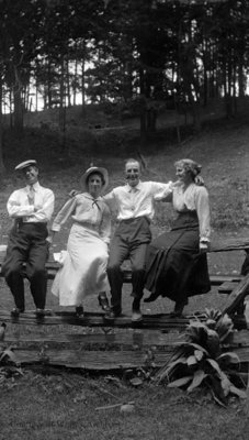 Unidentified Group Sitting on a Fence, c.1915