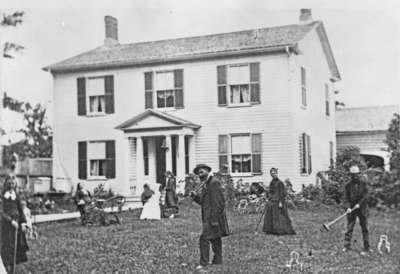 Several people playing croquet in front of the residence of Richard Hatch, c.1878