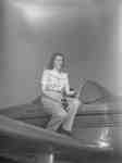 Unidentified woman sitting on a Ercoupe airplane, c.1940