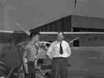An unidentified man and flight student standing in front of Aeronca Champion