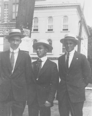 Three men standing at the Four Corners