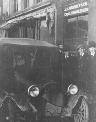 Four men and a car on Brock Street