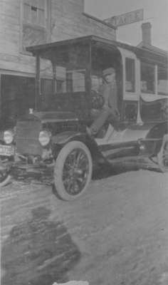 Man sitting inside Joseph Heard motor bus on Elm Street