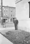 William Henry Hopper standing beside Standard Bank building