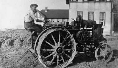 Louis Northam on a tractor in front of Ontario Hospital Whitby, c.1915