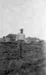 Man Standing in Front of Cottages, Ontario Hospital Whitby, c.1916