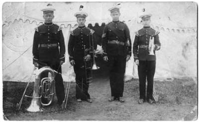 Four members of the 34th Regiment Band in front of a tent at Niagara-on-the-Lake Camp, 1910