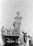 Major Bob Smith and a child standing on a makeshift reviewing stand, during 116th Battalion Soldiers Military Review, 1916