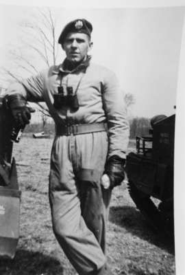 Portrait Photo of An Unidentified Soldier Standing with a pair of binoculars around his neck