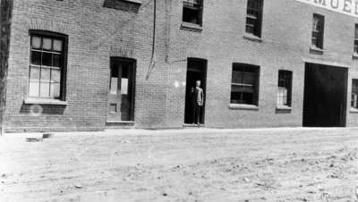 Samuel Trees standing in the doorway of Samuel Trees and Company (Blanket Factory), c.1915