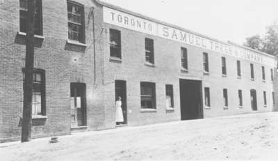 Laura Pellow standing in doorway of Samuel Trees and Company (Blanket Factory), c.1915