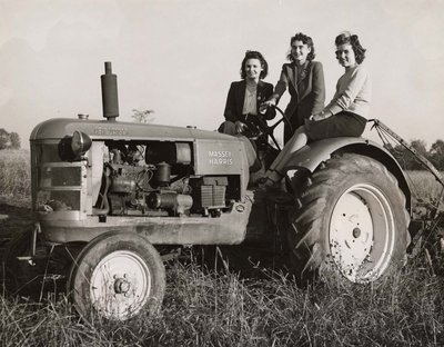 Three women on a tractor