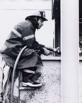 Ajax firefighter in action battling the Cashway blaze