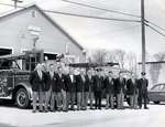The Ajax Fire Chief and Firefighters standing in front of the fire hall