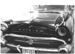 Damaged Buick hit by the Huxter’s Hardware Store truck, Ajax, 1960