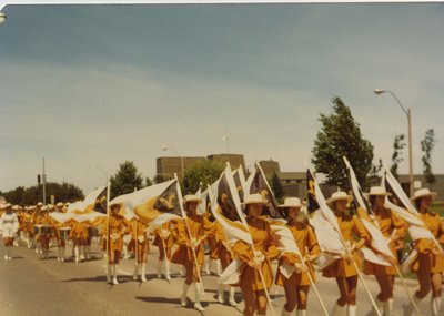 A female Marching Band and Flag Bearers