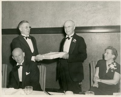 Man in Tuxedo receiving gift