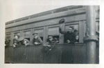 Soldiers waving from a train