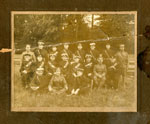 Group photo, 18 soldiers with 3 seated on the grass