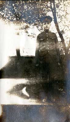 One soldier standing in front of a tree