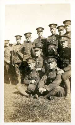 Group photo of 11 soldiers with 2 seated on the grass