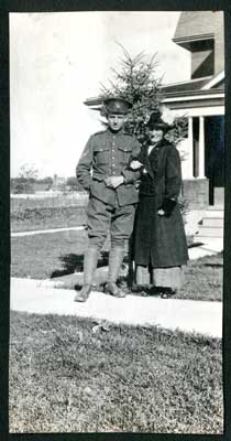 Soldier and woman standing in front of a house