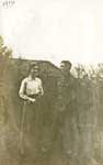 Soldier and young woman standing in front of a house