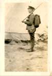 Side view of a soldier with a backpack and a rifle