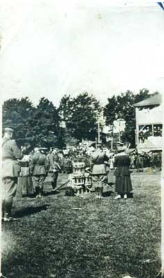 Photograph of 4 soldiers, 2 women and drums