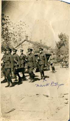 8 soldiers walking down a road