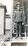 Young soldier in full uniform standing on outdoor stairs
