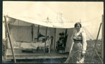 Woman standing in front of white, open sided tent
