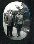 Photograph of 2 men on a boardwalk, one is a soldier